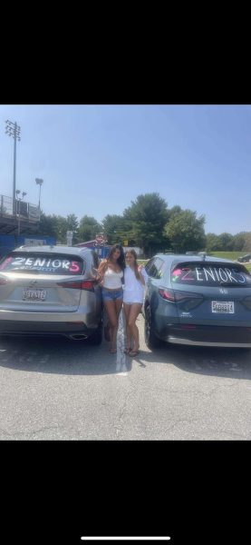 Seniors Aveen Ghias and Isabella Davis-Astrada take pictures and decorate their cars the day before school starts. 