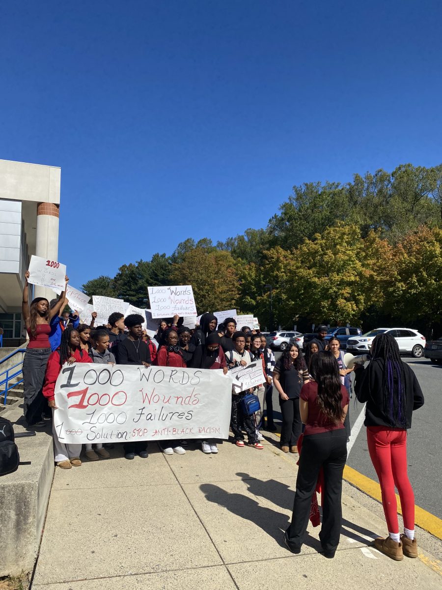 Senior Black Student Union co-presidents Leila Khademian and Teemo Taiwo lead a group of students in an anti-racist rally outside the front entrance on Oct. 17 during lunch, holding signs that read "1000 Words, 1000 Wounds, 1000 Failures, 1 Solution: Stop Anti-Black Racism." "It's showtime, this is what we've been building to for the last four years," Khademian said.