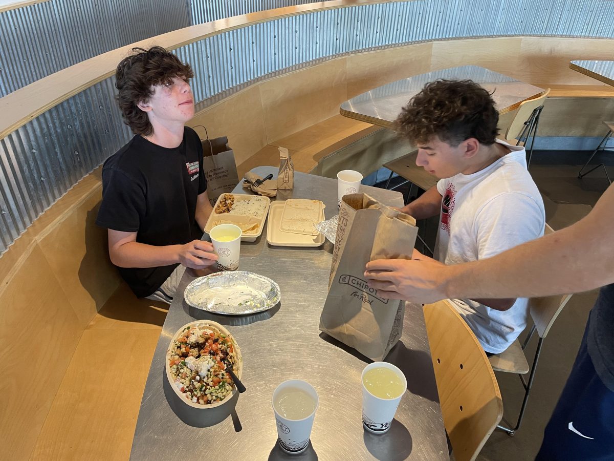 Sophomore Luca Phillips and senior Raimi Kvedys grab an after-school snack from their favorite fast food place, Chipotle, on Sept. 30.