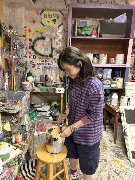 Junior Natalie Chen mixes paint for props backstage. "I'm the stage manager, so now I have to do stage managing and make lighting keys for two shows, and that's kind of crazy," Chen said. 