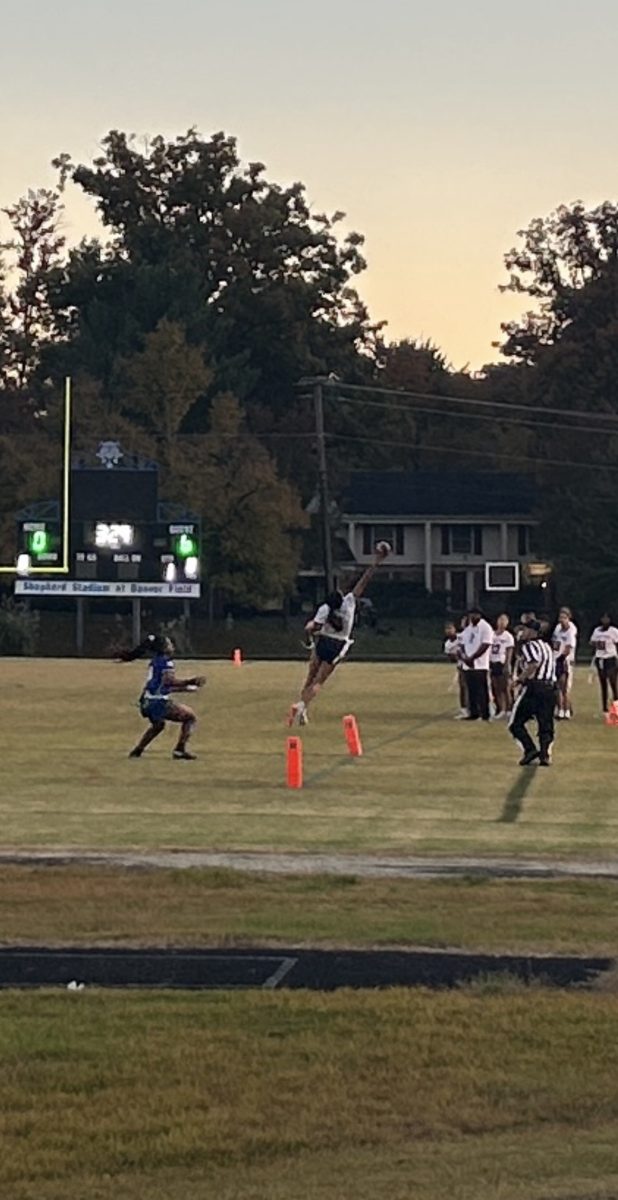 Junior Megan Lomotan leaps for this pass in the endzone. Lomotan had a touchdown and interception in this 14-0 victory over Churchill. "It [the win] definitely gave us confidence because now we know what we are capable of both on offense and defense," Lomotan said.