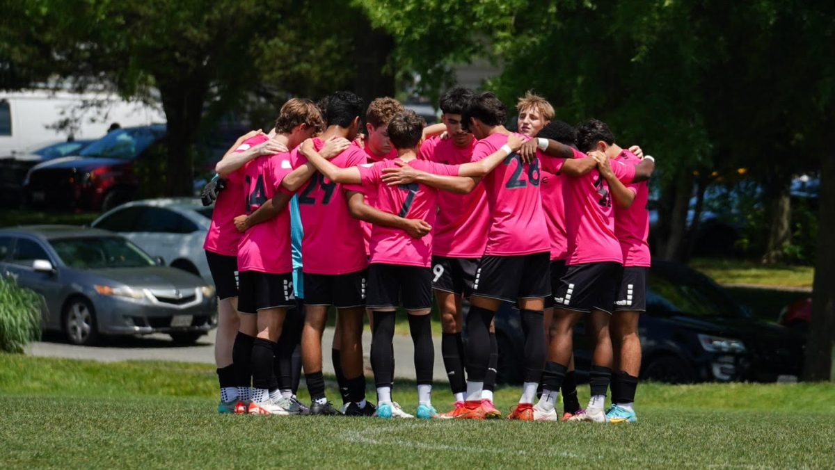 Junior Aadi Chaudhari's Potomac Soccer Association team huddles before a match. "My team was a family where everyone appreciated each other, our bond strengthened each practice and game, no matter win or lose," Chaudhari said.