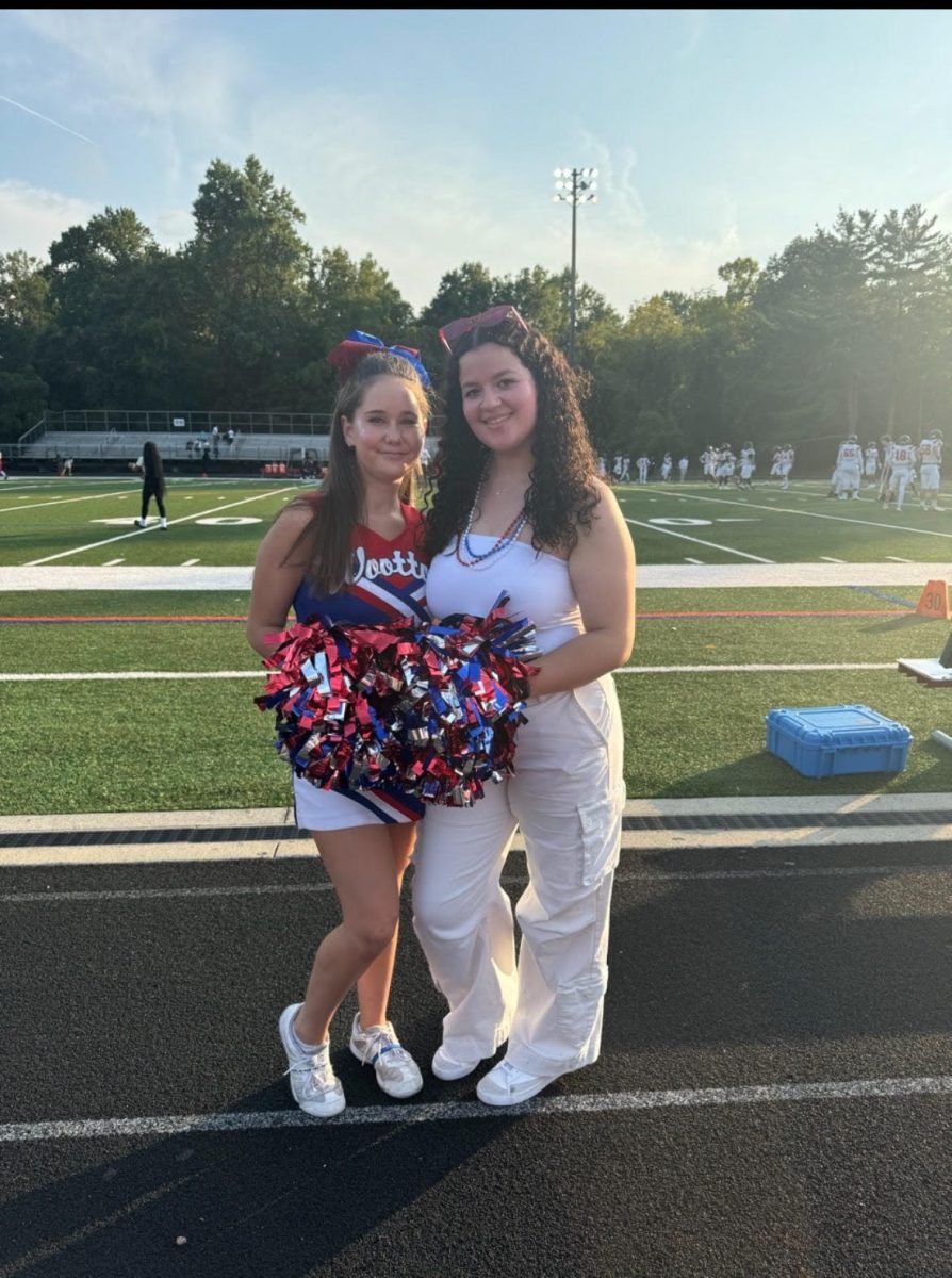 New cheer coach Samaris Sirano-Rodriguez taking pictures with sophomore Shayna Fleischer (this writer) before the second home football game against Gaithersburg on Sept. 26.