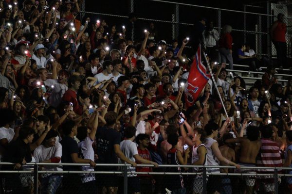 Students cheer at the USA-themed football game against Rockville in the home opener. This was the second-highest-voted theme of the season.