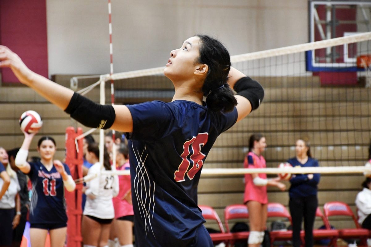 Sophomore Haile Ma hits during the varsity girls' volleyball game against BCC on Monday, Sept. 9.