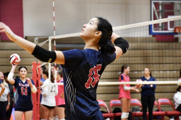 Sophomore Haile Ma hits during the varsity girls' volleyball game against BCC on Monday, Sept. 9.