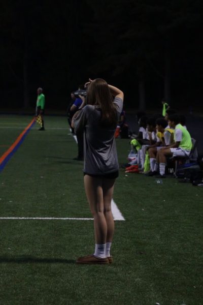 Sophomore Claire Weed takes photos at the boys' soccer game on Oct. 23. Weed has done sports photography for the soccer, football, flag football and volleyball teams. "All the players on the team really like to see themselves in pictures and I’ve gotten to know a lot of people," Weed said.