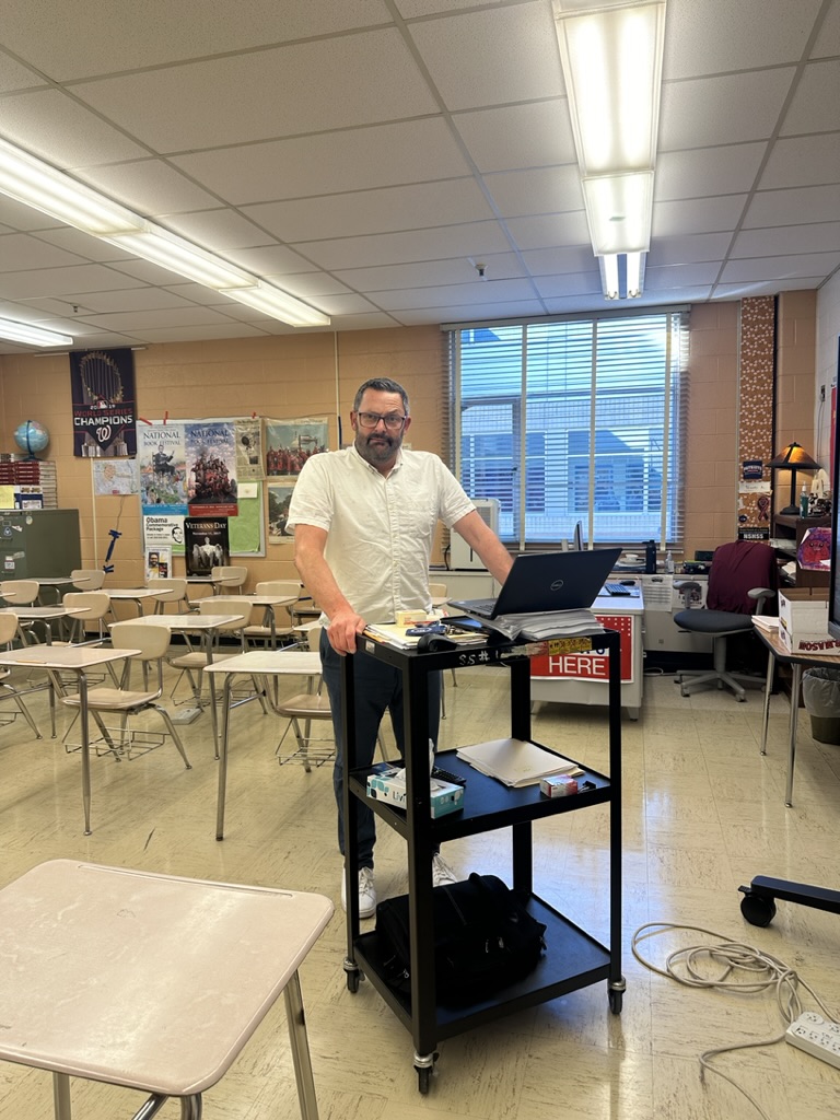 On Oct. 24, social studies teacher Timothy Anderson rolls from his office back to his classroom, which another teacher occupies during a class period.