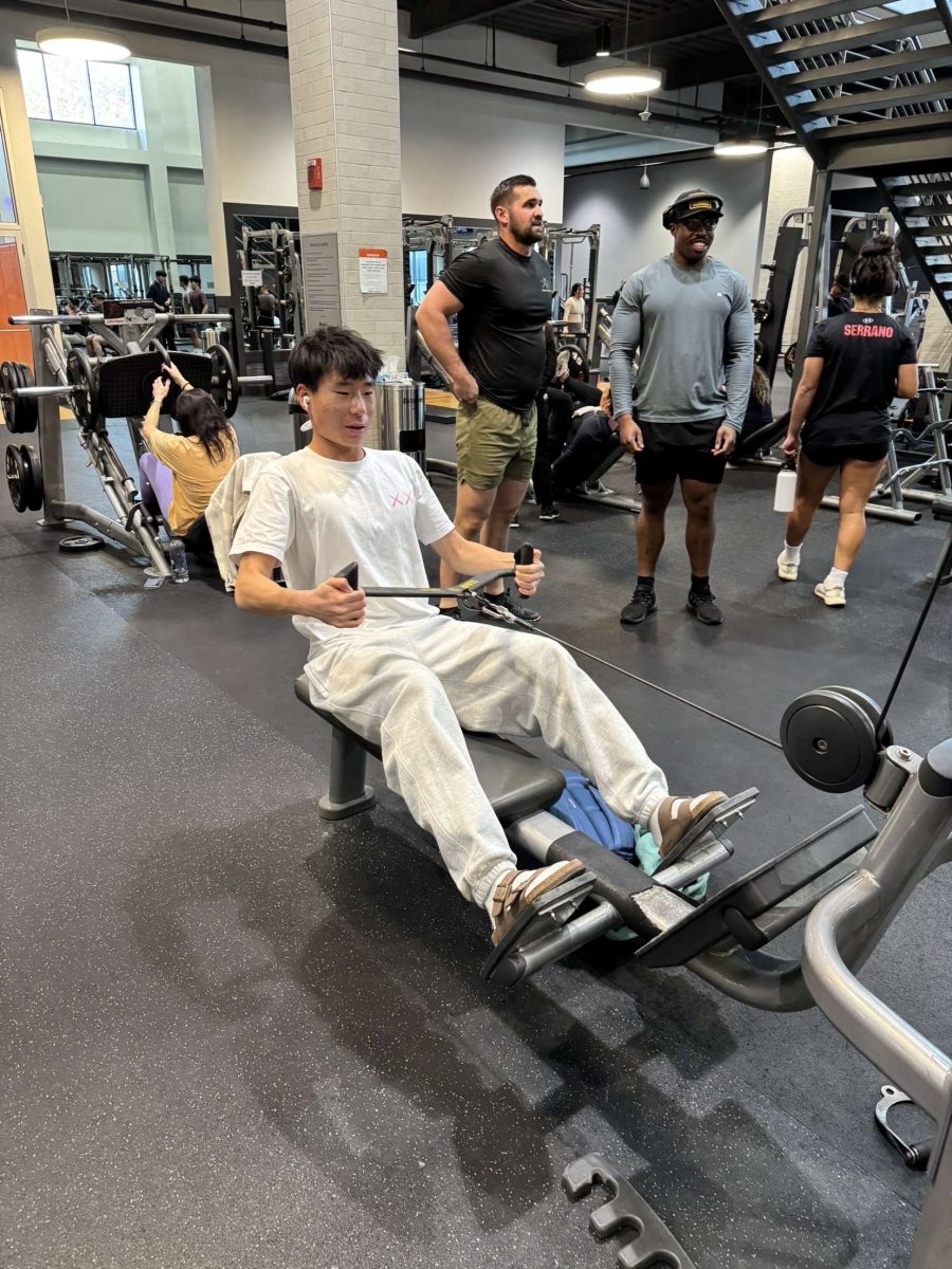 Junior Kevin Sun, a member of the boys' varsity soccer team, works out at Lifetime Gym on Nov. 13. Sun said he strives to get bigger so he can push people off the ball more easily. "If I lift more weights, it'll be easier to win balls in the midfield," Sun said.