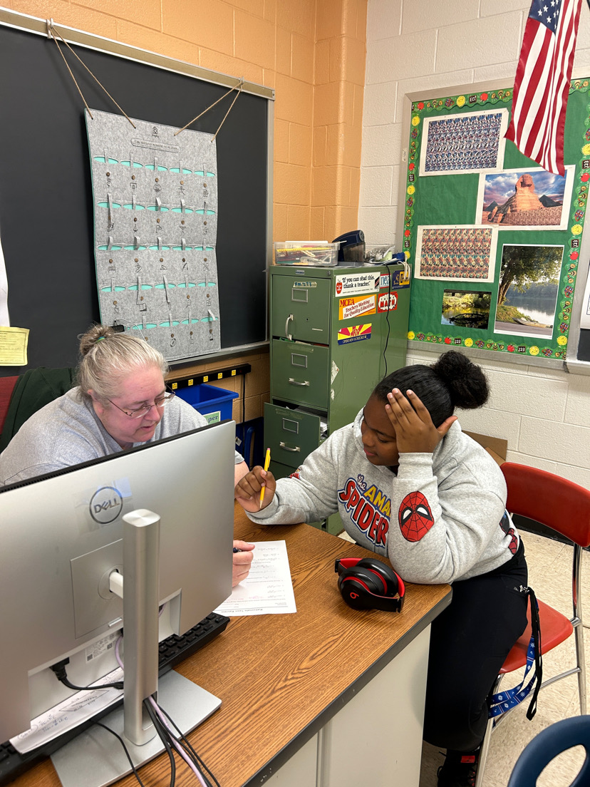 Geometry and pre-calc teacher Catherine Ruback helps junior Skylar Wade with her pre-calc worksheet. Ruback is passionate about helping her students understand their work.