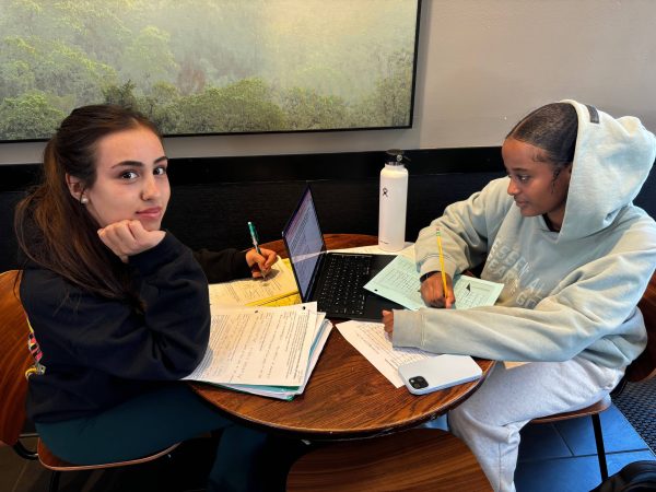 Sophomores Lale Olguin (left) and Edlawit Abebe (right) work on Honors Chemistry homework while waiting for drinks at Starbucks.