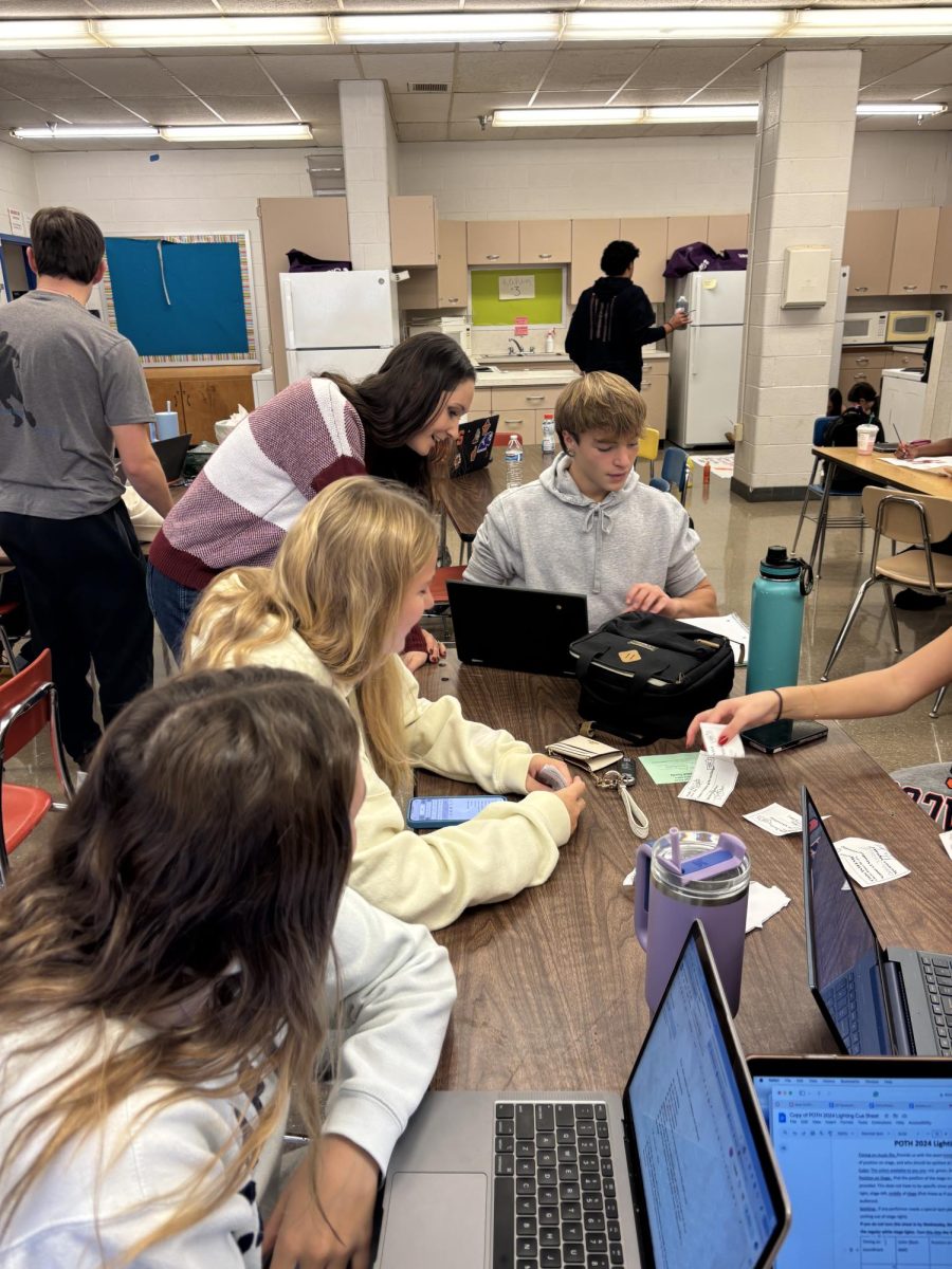 Health teacher and Splanning sponsor Victoria McCarthy helps senior Kyle Fuster on an assignment during fourth period on Nov. 21.