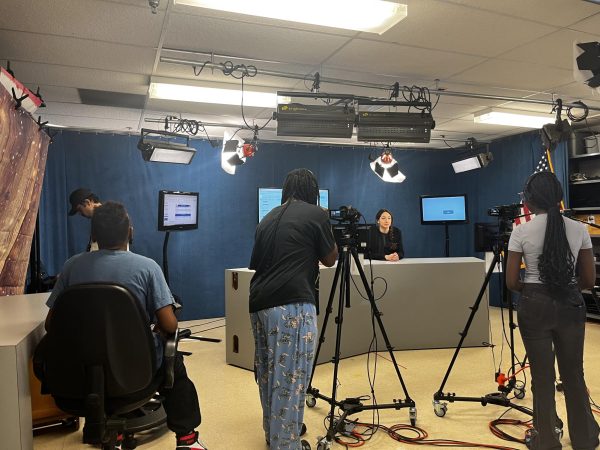 Junior Anna Nishniadize prepares to film the daily Patriot TV News episode for Dec. 11 in TV Studio, a class that fosters a "community of creative people coming together and using that creativity for class," freshman Amari Brown said.