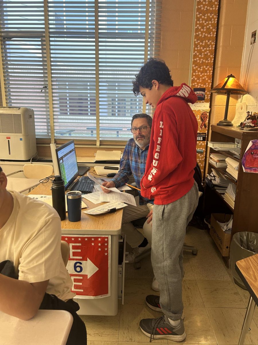 During the morning of Dec. 10, history teacher Timothy Anderson helped a student during an AP United States History quiz. Anderson encourages students to ask questions.