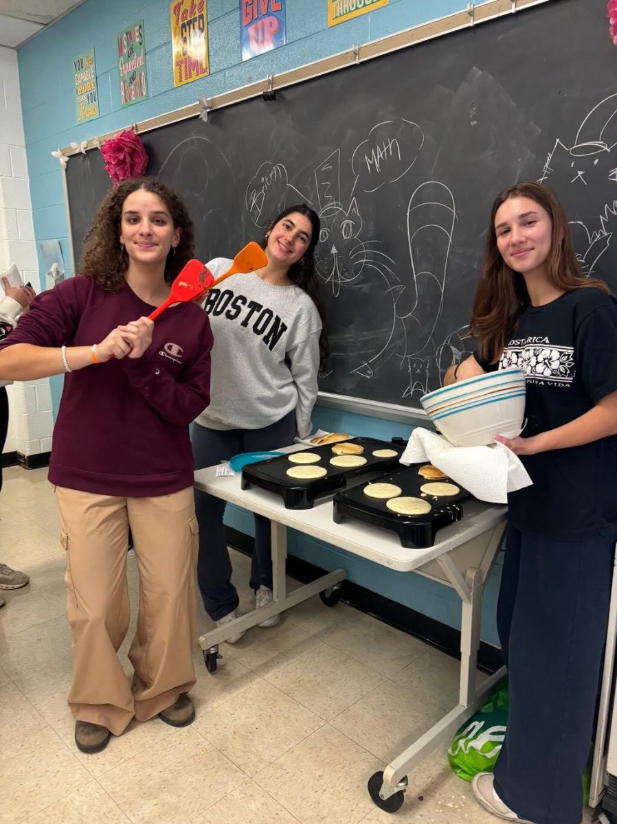 Seniors Anna Lizondo, Daniela Riba and Maria Daraselia make pancakes for Breakfast Club. "Breakfast Club is a welcoming place to come hang out and socialize," Lizondo said.