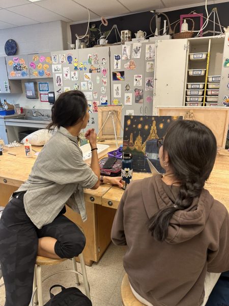 Art teacher Quan Duong (left) works with her students during her fourth period AP Art class.