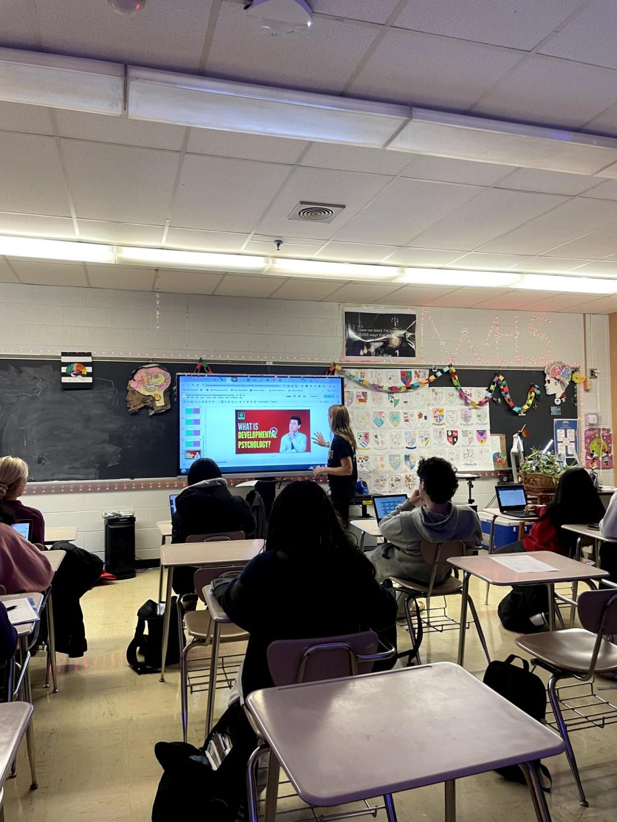 On Friday, Nov. 22, AP Psychology teacher Amy Buckingham tells her third period about the new unit  "Development and Learning" concepts they will be studying over the next month. She started by discussing nature vs. nurture and then provided a video about developmental psychology.