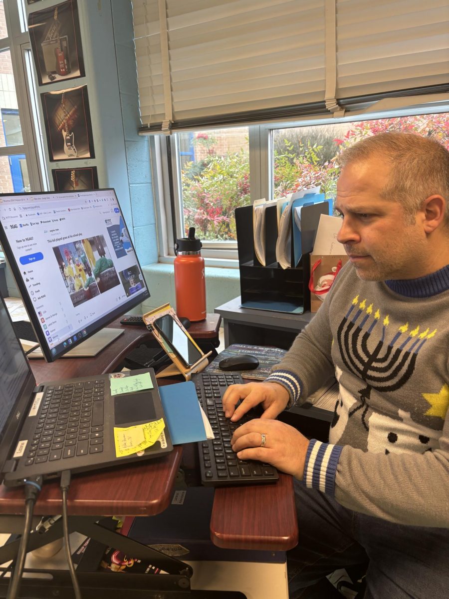 Dr. Julian Lazarus works on an assignment for his students during advisory on Monday, Dec. 16.