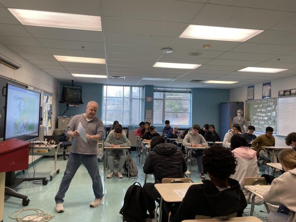 Honors modern world history teacher Kraig Bauer explains how to complete a worksheet to his fourth period class on Jan. 3.