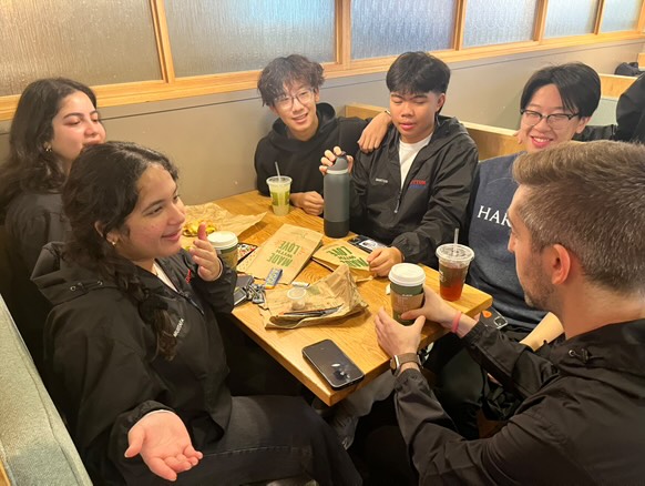 Choral director and class sponsor Keith Schwartz joins Acatonic seniors Aiden Feng, Naysa Mustafa, Joy Nadda, Kelvin Zhou and sophomore Benedict Santos for a team breakfast on Tuesday, Dec. 17, at Panera in Fallsgrove. The group gathered ahead of their visit to feeder schools, where they promoted a cappella as an elective option and performed songs they had learned over the past four months. “I’ve had Mr. Schwartz as a teacher for four years, and every year I feel like I learn more about him and more about myself. Schwartz has taught me to be more timely and responsible,” Nadda said.