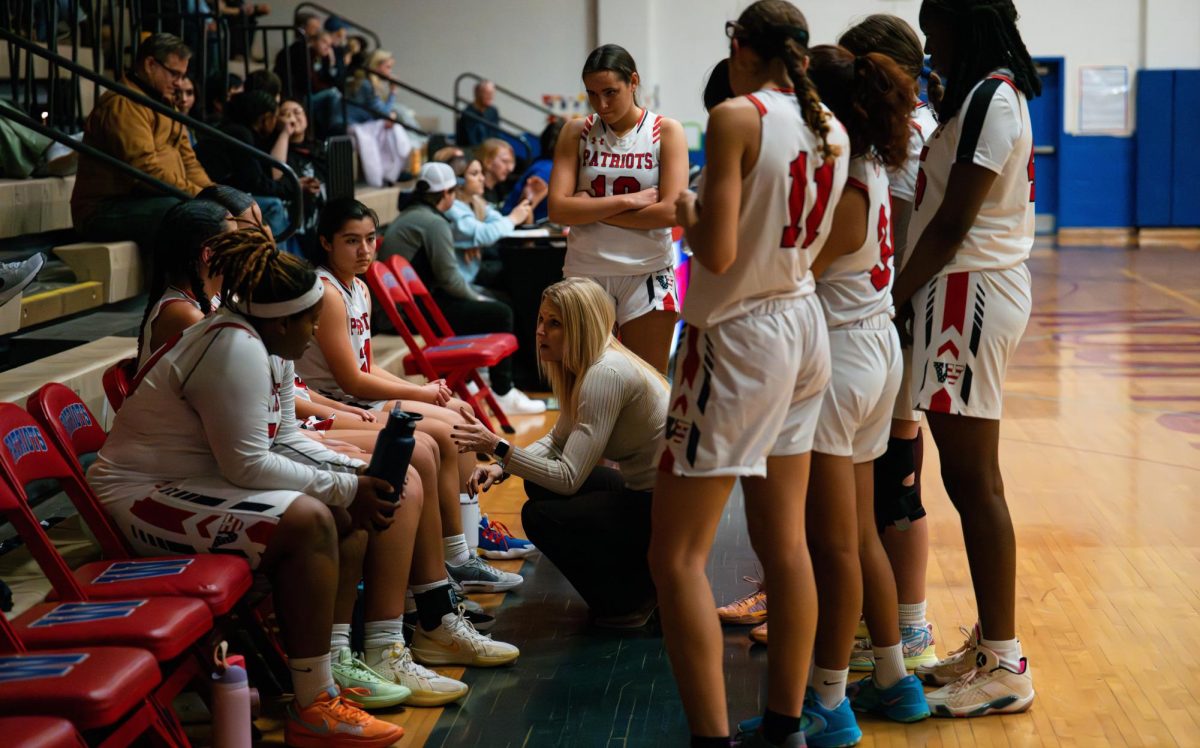 Coach Maggie Dyer talks to the team during a break as they play Whitman at home. 
