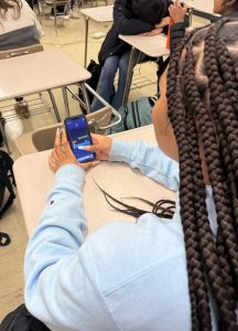 Junior Kirsten Sinkler uses her break from school work to play Block Blast on Jan. 13.