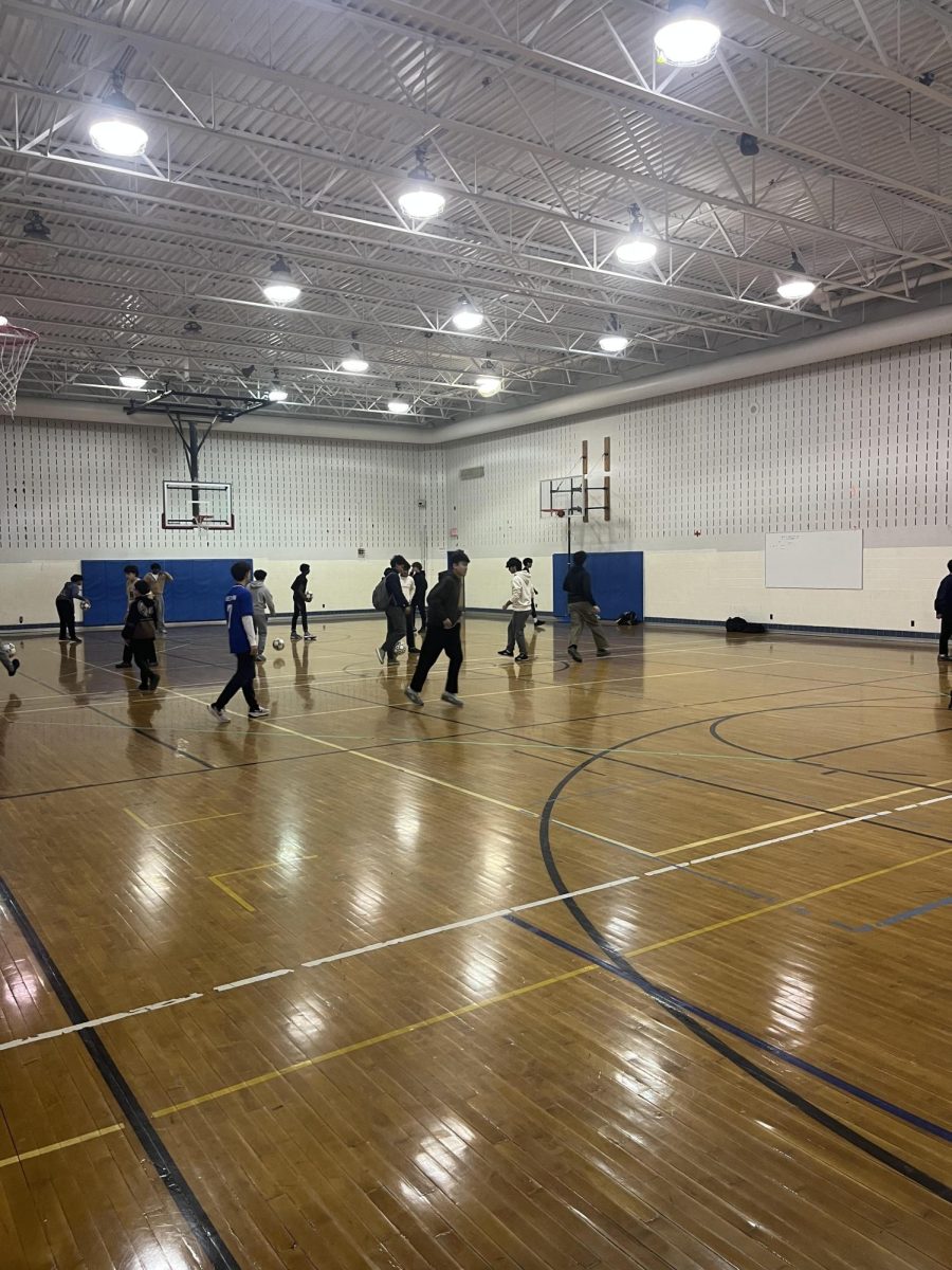 Students play soccer in the auxiliary gym during fourth period P.E. class.