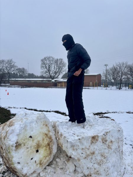 Junior Shreyas Ganeshan enjoys his day off of school by building snow sculptures at Travilah Elementary School on Wednesday, Feb. 12. "I was able to spend valuable time with my friends during the snow day," Ganeshan said.