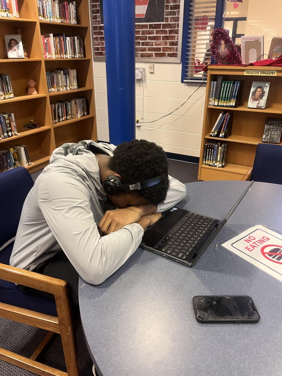 Junior Bryan Ngouzo puts his head down in the library during advisory.