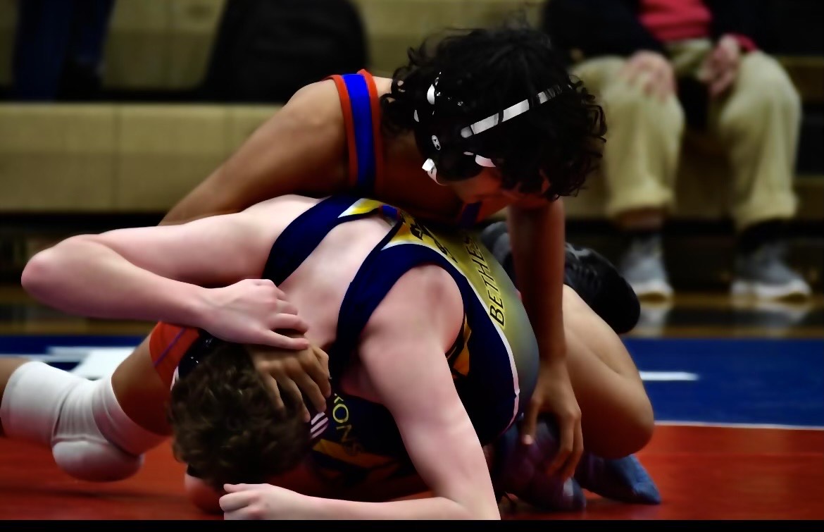 Varsity wrestler Mohammed Uddin competes in match against B-CC and scores a win.