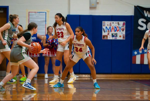 Senior Maddy Matthews plays defense against a Churchill player during senior night on Feb. 4. Senior night was memorable for Matthews "because it was fun to play [in]," she said.