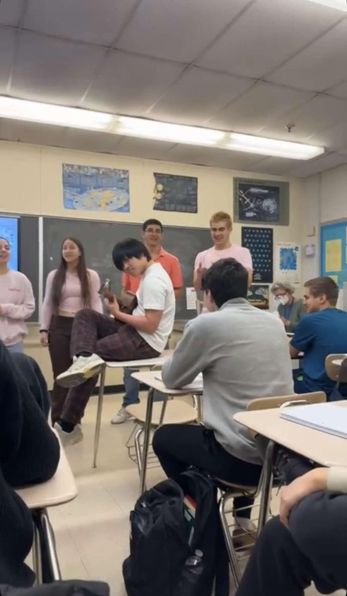 Senior Jake Skalias listens to the a capella group perform a singing Valentine that was ordered by one of his friends.