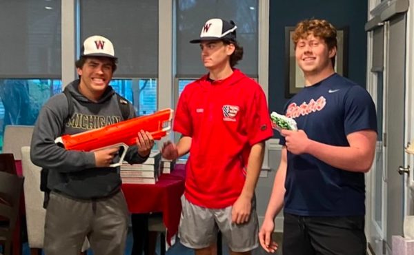 Class of 2024 seniors Lucas Sossa (left) and Noah Parker (right) show off the elimination of their target Justin Karis (middle) during a baseball team bonding event during last year's game on Apr. 2.