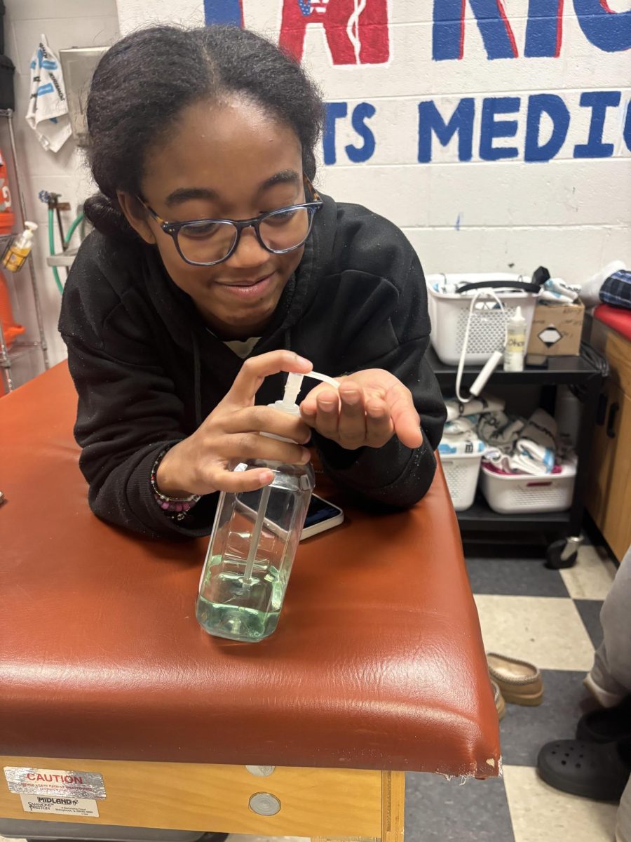 Senior and athletic training intern Leanne Brown sanitizes her hands after shaking hands with someone. "I try not to come off as a germaphobe but ever since the pandemic I've started carrying hand sanitizer wherever I go so that I can always make sure I'm as clean as I can be," Brown said.