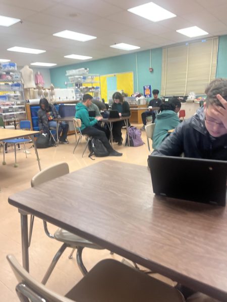 Students in a shelter-in-place drill quietly work while waiting for instruction.