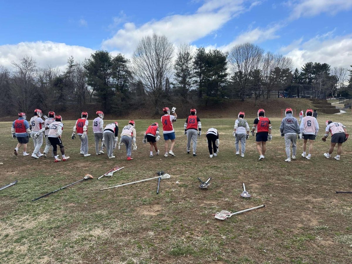 The boys' lacrosse team warms up before their Mar. 6 practice session. "We always stress that our athletes should stay active and try to play as much summer and fall ball as possible. Work-out routines include gym and track time. Coaches want to kids to come in shape for the season instead of using the season to get into shape," Phillips said.