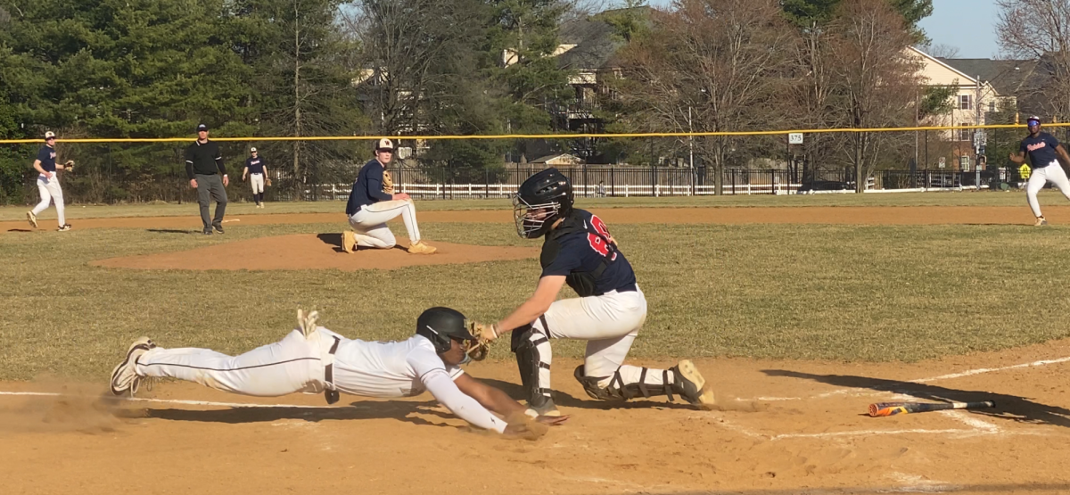 Junior catcher Kai Schmelzer slaps a tag on the runner in a 2-5 scrimmage loss against Northwest on Mar. 12.