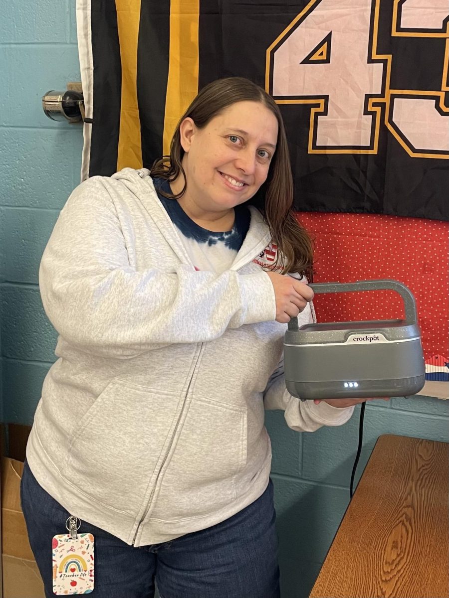 AP Statistics teacher Michelle George shows off her leftover Chipotle bowl that she packed for lunch and warmed in her crockpot on Mar. 14. "I use little crock pots to heat stuff at my desk without having to go find a microwave, or wait in line for a microwave because we only have a couple in the math office," George said.