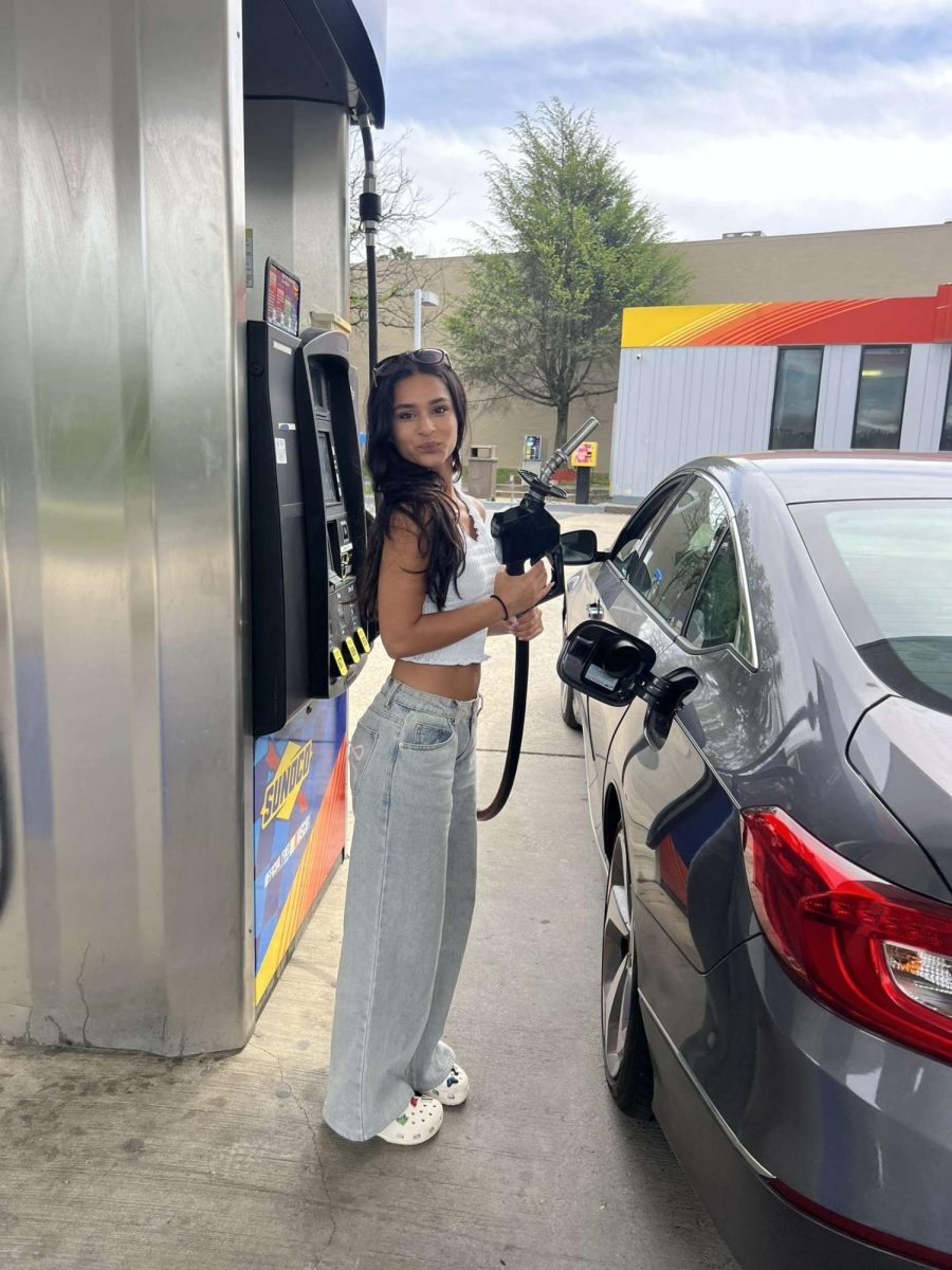 Junior Alina Parikh fills her tank at the Sunoco gas station next to Trader Joe's.
