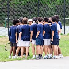 Boys' tennis team huddles up before a match. The team swept Richard Montgomery 7-0. "I think we have a great chance of repeating as long as we all play our best," Balian said.