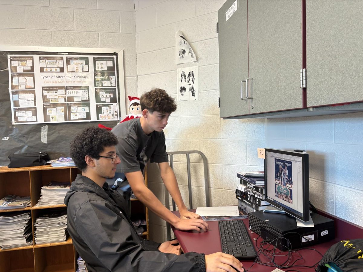 Editor-in-Chief emeritus, senior Alex Balian, helps Editor-in-Chief and junior Ahmed Ibrahim create the cover of Common Sense's print issue on May 12 during their third period Newspaper class.