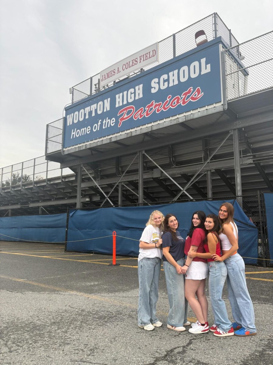 Senior Emma Karcz (this writer, far left) and friends Abby Needleman, Alexa Schnur, Lainey Berman and Nikki Cohen celebrate in their college merchandise at the annual senior picnic on Friday, May 16.