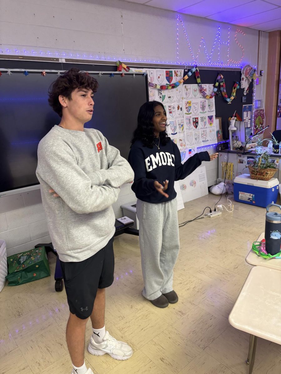 Seniors and co-presidents of SGA Alex Balian and Ashi Stanislaus present the daily agenda to members on May 7 during period 4 in sponsor Amy Buckingham's room. Stanislaus said, "I wish I was able to get involved in freshman year or start my journey in these clubs earlier because I think the earlier you start, the more opportunities you have."