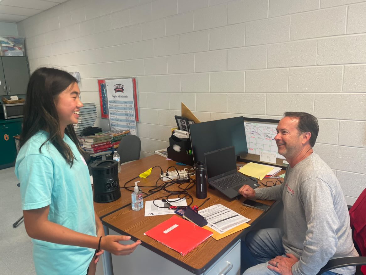 Junior Megan Lomotan approaches history teacher and varsity girls' soccer coach Chris Thompson after school on Friday, May 2, in the history department office to ask for a college recommendation letter. While Lomotan felt anxious, Thompson agreed to write the letter. "It has crossed my mind to start making my recommendations more selective, but generally speaking, I try to write a letter for everyone that asks," Thompson said.