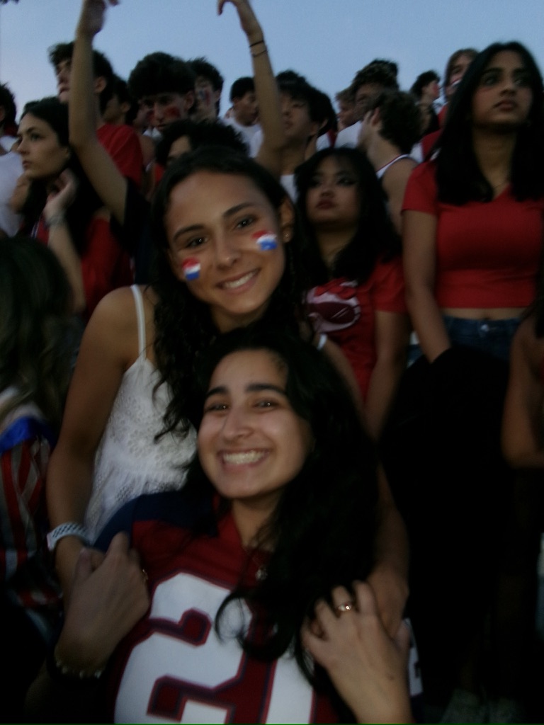 Seniors Inayat Thukral (this writer) and Mia Silbert celebrate at their last first football game on Sep 13.