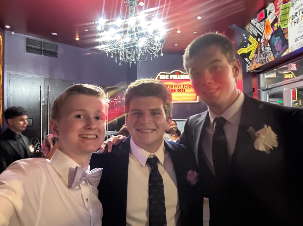 Seniors Aaron Dowd, Zachary Derman, and Lucca Engel take pictures at the Fillmore for prom on Saturday, May 17.