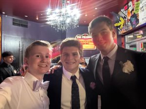 Seniors Aaron Dowd, Zachary Derman, and Lucca Engel take pictures at the Fillmore for prom on Saturday, May 17.