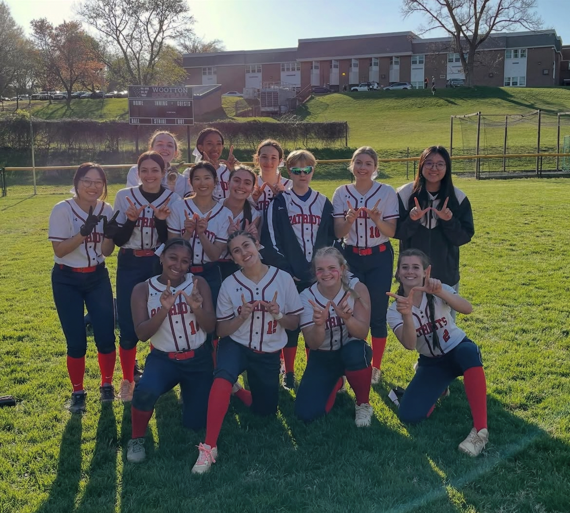 The softball team holds up W's after their 10-run win against Kennedy on Apr. 9. The Patriots are set to play them again in the first round of playoffs on May 12.
