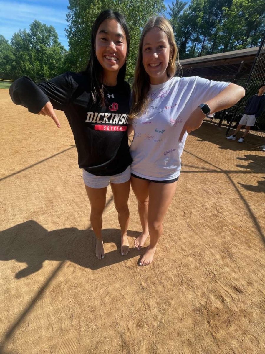 Junior Megan Lomotan (left) and senior Emily Teague play kickball barefoot. "Since I wore flip flops to school I was able to play barefoot and was at an advantage," Lomotan said.
