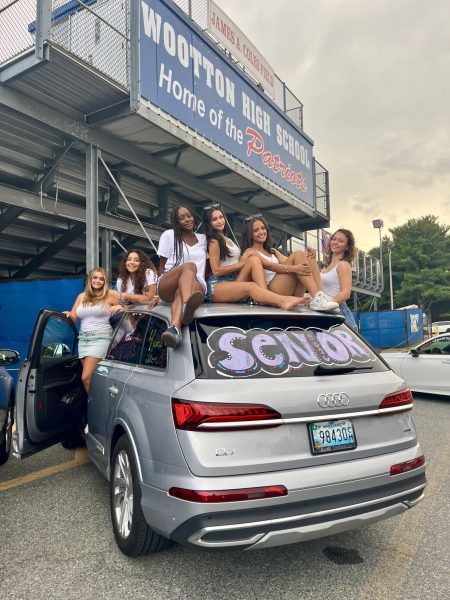 Seniors Zoi Bourazani, Roshali Nemaya, Gabriella Gberby, Alina Parikh, Ruth Bayou and Sophia Shapiro showcase their graduation-themed car decorations in front of the football stadium. Photo courtesy Gabriella Gberby